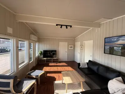 a living room with a couch and a table at Sveastranda Camping in Gullor