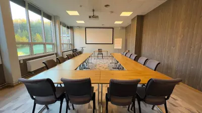 a conference room with a long table and chairs at Honne Hotell in Biri