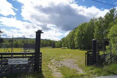 a gate to a pasture with a sign on it at Bustad Hyttetun in Skåbu
