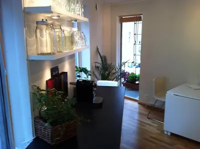 a living room with a counter and some plants at Central location in the heart of historic Bergen in Bergen