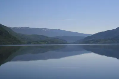 a large body of water with mountains in the background at Bøflaten Camping AS in Vang I Valdres