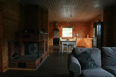 a living room with a brick fireplace in a kitchen at Bøflaten Camping AS in Vang I Valdres