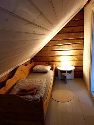 a bedroom with a bed in a wooden room at Fjords view in Sjøholt