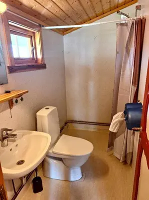 a bathroom with a toilet and a sink at Mindresunde Camping in Mindresunde