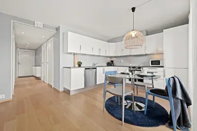 a kitchen and dining room with a table and chairs at BJØRVIKA APARTMENTS, Solsiden Area, Trondheim city center in Trondheim