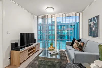a living room with a couch and a tv at BJØRVIKA APARTMENTS, Solsiden Area, Trondheim city center in Trondheim