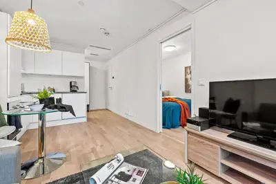 a living room with a large flat screen tv at BJØRVIKA APARTMENTS, Solsiden Area, Trondheim city center in Trondheim