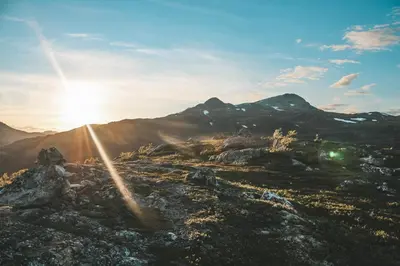 a view of a mountain with the sun shining on it at Sjoaasen Hytte in Tuddal