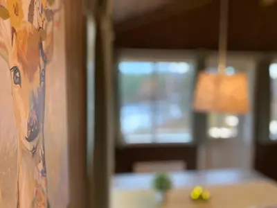 a room with a painting of a woman on a wall at Trysil Hyttegrend in Trysil