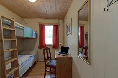 a room with a desk and a laptop on a table at Trysil Motell & Vandrerhjem in Trysil