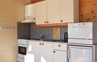 a kitchen with white appliances and white cabinets at 3 Bedroom Lovely Home In Vallavik in Vangsbygd