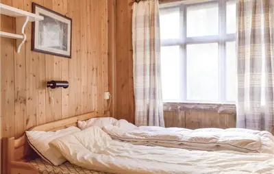 an unmade bed in a room with a window at 1 Bedroom Cozy Home In Vallavik in Kaland