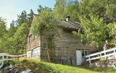 an old wooden house with a white fence at 1 Bedroom Cozy Home In Vallavik in Kaland