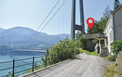 a road in front of a bridge with a red marker at 1 Bedroom Cozy Home In Vallavik in Kaland