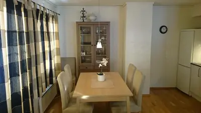 a dining room with a wooden table and chairs at Røldal in Røldal