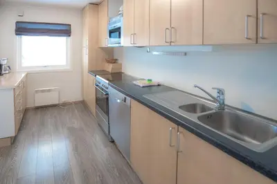 a kitchen with a sink and a counter top at Fjelltun 12-Sengs in Trysil