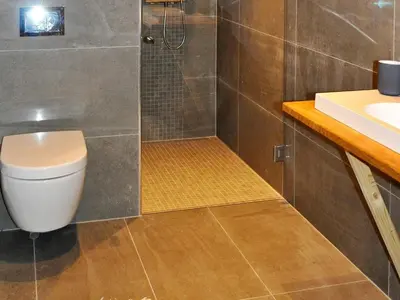 a bathroom with a shower with a toilet and a sink at 12 person holiday home in Fåvang in Favang