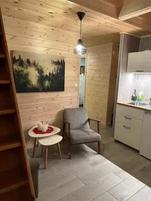 a kitchen with a chair and a table in a room at Haugo Utleige Lodge in Vossevangen
