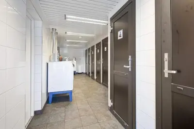 a hallway with a row of stalls in a room at Midttun Motell & Camping AS in Bergen