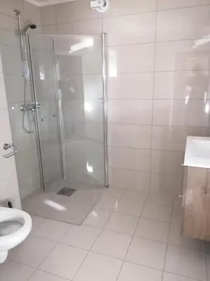 a bathroom with a shower and a toilet and a sink at Atlanterhavsveien Rorbuer in Averoy