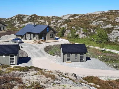 a house with a solar roof on a mountain at Atlanterhavsveien Rorbuer in Averoy
