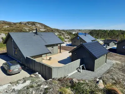 a house on a hill with a car parked in front at Atlanterhavsveien Rorbuer in Averoy