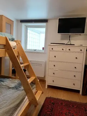 a bedroom with a bunk bed and a dresser at Sognevegen 2242 in Haugsvær