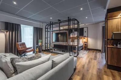 a living room with a couch and a tv at Radisson Blu Royal Garden Hotel, Trondheim in Trondheim