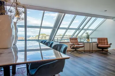 a conference room with chairs and a table and windows at Radisson Blu Royal Garden Hotel, Trondheim in Trondheim