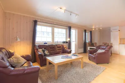 a living room with leather furniture and a coffee table at Fjelltun 8-sengs in Trysil