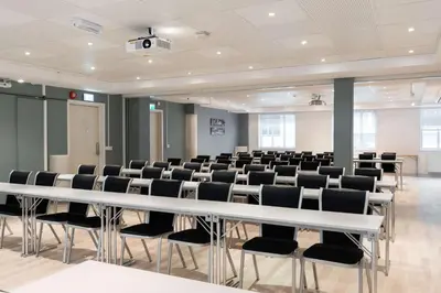 a conference room with a white table and chairs at Scandic Bergen City in Bergen