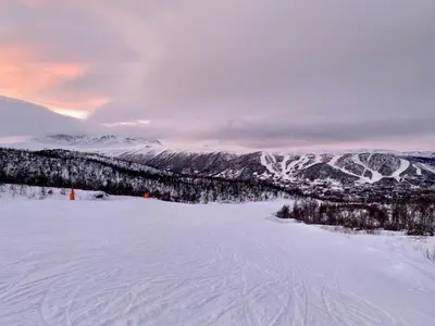 a view of a snow covered slope with mountains at Hakkesetstølen Fjellstugu in Geilo