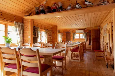 a dining room with a long table and chairs at Hakkesetstølen Fjellstugu in Geilo