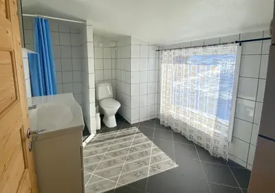 a bathroom with a toilet and a sink and a window at Hakkesetstølen Hytter in Geilo