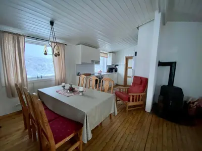 a kitchen and dining room with a table and chairs at Hakkesetstølen Hytter in Geilo