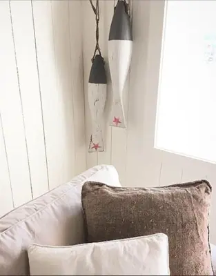 a living room with a white couch and a window at The Boathouse in Råkvåg