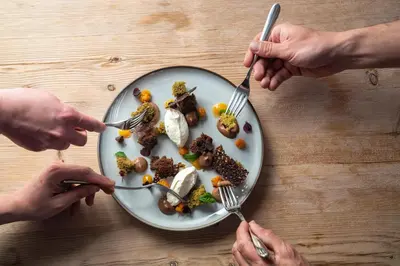 a group of people eating a plate of food at Sommerhotellet in Vang I Valdres