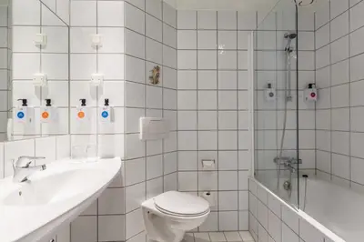 a bathroom with a toilet and a sink and a shower at Vøringfoss Hotel in Eidfjord
