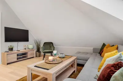 a living room with a couch and a tv at Høyden Apartments in Bergen