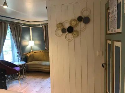 a living room with a door and a couch at Grønset Skysstasjon in Vinjeøra