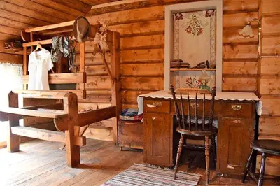 a room with a wooden cabin with a desk and a chair at Kjørsvik Øvre in Tornes