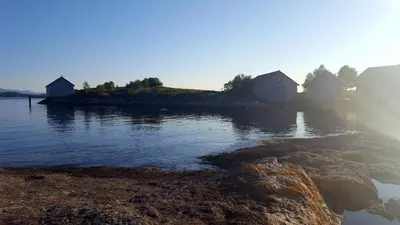 a small island in a body of water at Kjørsvik Øvre in Tornes