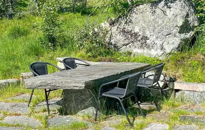 a wooden table with four chairs around it at Amazing Home In Jøsenfjorden With Sauna in Gullingen