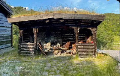 an old cabin with a grass roof with a fireplace at Amazing Home In Jøsenfjorden With Sauna in Gullingen