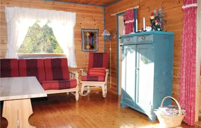 a living room with two chairs and a stove at 3 Bedroom Beautiful Home In Voss in Vossevangen