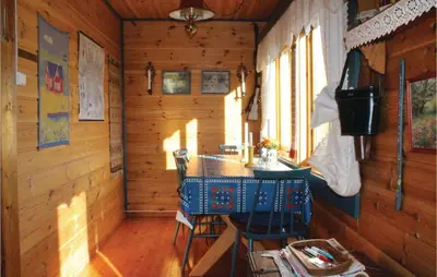a room with a table and chairs in a cabin at 3 Bedroom Beautiful Home In Voss in Vossevangen