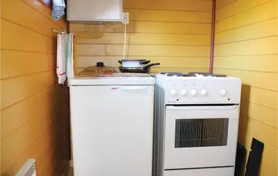a kitchen with a stove and a white refrigerator at 3 Bedroom Beautiful Home In Voss in Vossevangen