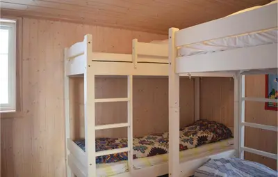 a bedroom with two bunk beds in a cabin at Four-Bedroom Holiday Home In Eggedal in Eggedal