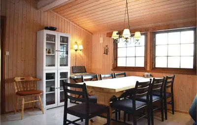 a dining room with a table and chairs at Four-Bedroom Holiday Home In Eggedal in Eggedal