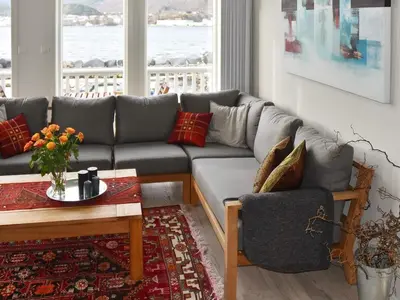 a living room with a couch and a table at 10 person holiday home in Brattvåg in Brattvåg